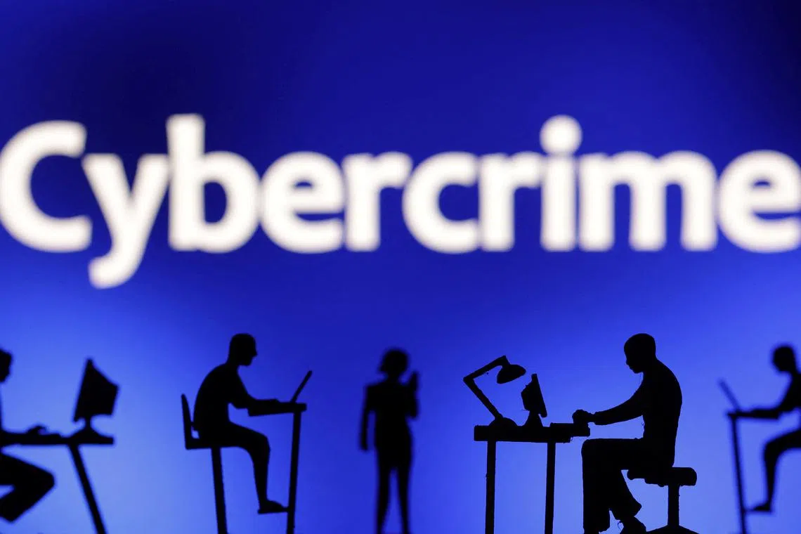 Figurines with computers and smartphones are seen in front the word \"Cybercrime\" in this illustration taken, February 19, 2024. REUTERS/Dado Ruvic/Illustration