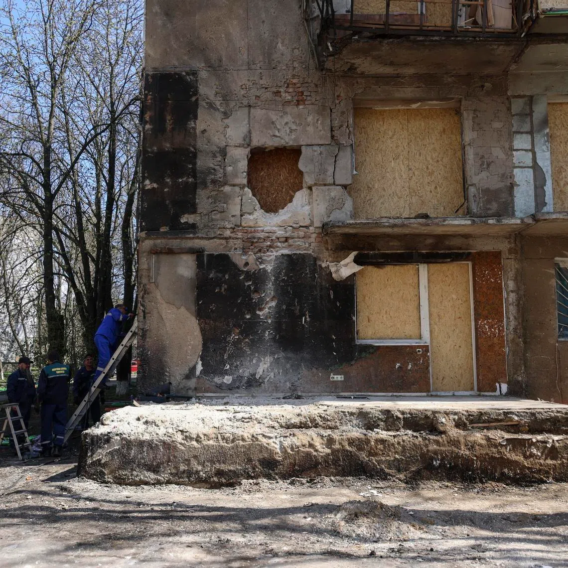 Ukrainian communals work at the site of a Russian strike on a residential building in Odesa, Ukraine, on April 5.