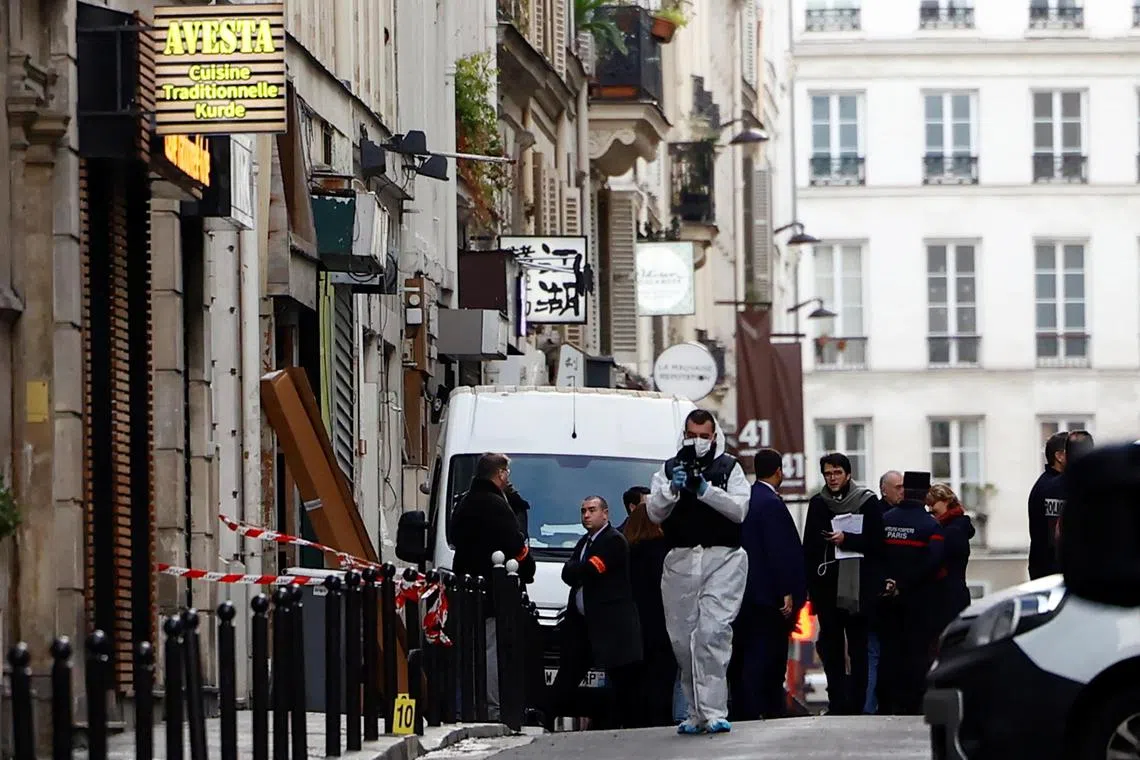 French scientific police work on Rue d'Enghien after gunshots were fired, killing and injuring six people in a central district of Paris, France, on Dec 23, 2022. 