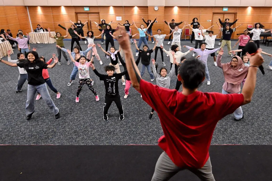 ST20240903_202443200605 Kua Chee Siong/ edchildaid/
Front row from L to R: Kaylen Thawdar Hnin Htet, 15 years old, Travis Wong Kai Xuan, 9 years old, Jemima Liew-Yeo, 10 years old, Husna Humaira Bte Muhamad Hairie, 15 years old and Hafeez Hav Hassan, Chief Choreographer, at the three-day workshop for ChildAid 2024 The Dream Emporium.
The young talents who will be performing at ChildAid 2024 will take part in workshops held at the SPH Auditorium. The 20th edition of the charity concert organised by The Straits Times (ST) and The Business Times will take place at the Esplanade Theatre on Nov 29 and 30.