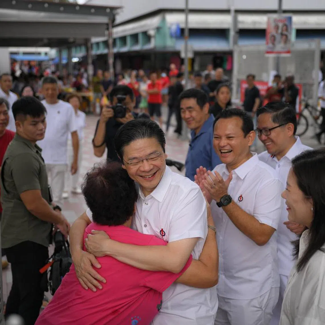 PM Lawrence Wong (centre) and other members of the Marsiling-Yew Tee GRC team at Marsiling Market on May 5.