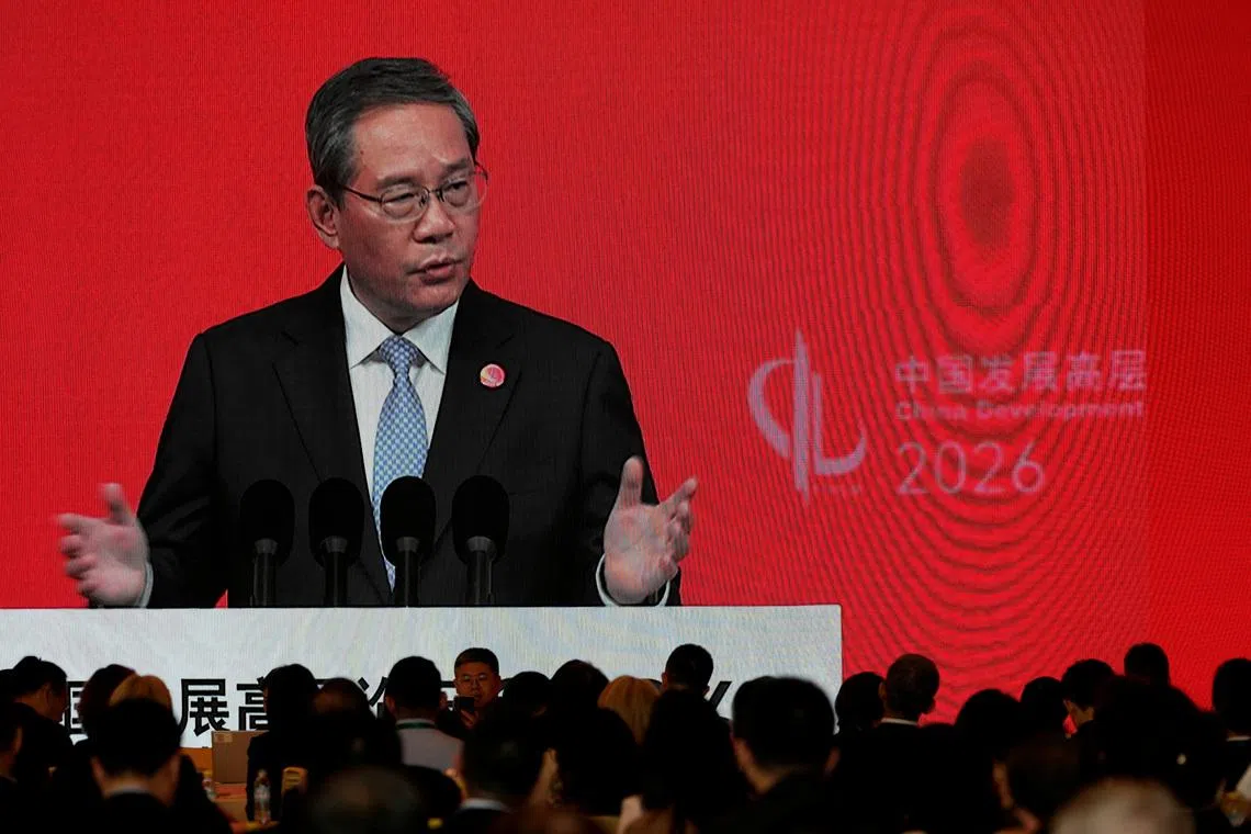 Chinese Premier Li Qiang on a big screen live broadcasting his speech at the opening of the China Development Forum 2026 held at the Diaoyutai State Guesthouse in Beijing, China, March 22, 2026.Ng Han Guan/Pool via REUTERS    Ng Han Guan/Pool via REUTERS