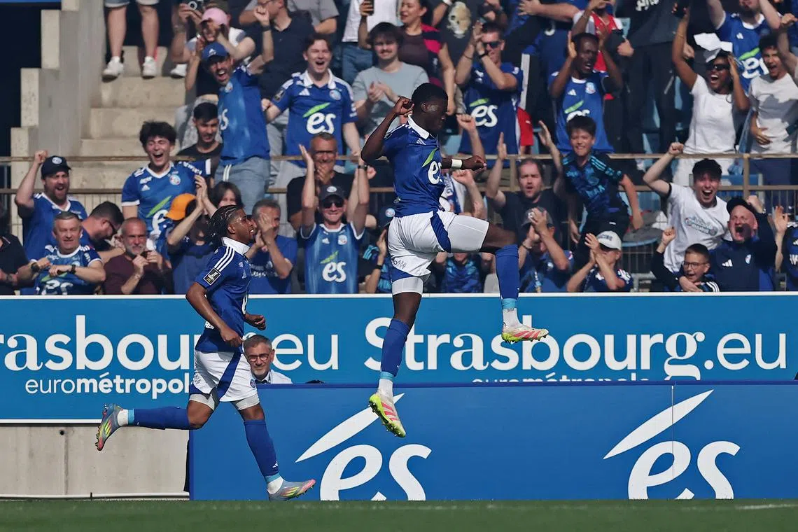 FILE PHOTO: Soccer Football - Ligue 1 - RC Strasbourg v Paris St Germain - Stade de la Meinau, Strasbourg, France - May 3, 2025 RC Strasbourg's Mamadou Sarr celebrates their first goal, an own goal scored by Paris St Germain's Lucas Hernandez/File Photo