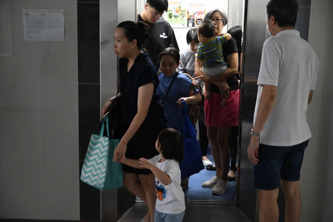 Residents leave their flat 7:40am prior to the detonation of a WWII bomb at a nearby construction site on Sept 26.