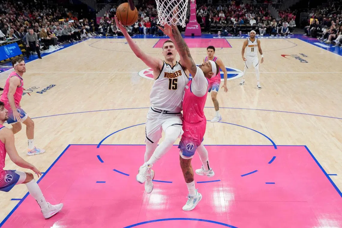 Nikola Jokic of the Denver Nuggets going up against Daniel Gafford of the Washington Wizards during the second half at Capital One Arena.