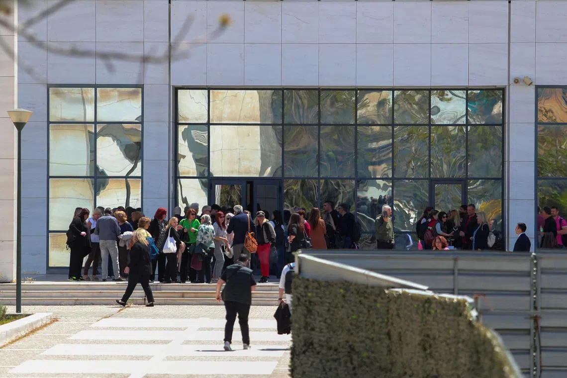 People gathering outside a courthouse in Athens following a shooting incident that left several wounded on April 28.
