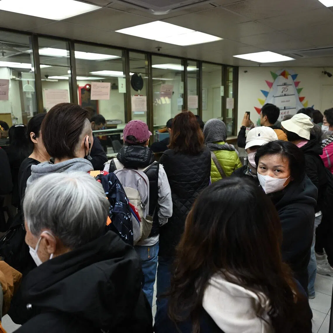 People queue inside a gold dealer in Hong Kong to buy up bars of silver.