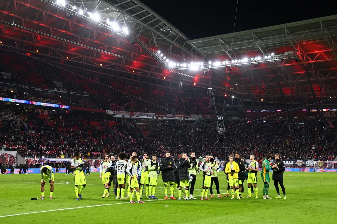 Soccer Football - Bundesliga - RB Leipzig v Borussia Dortmund - Red Bull Arena, Leipzig, Germany - February 21, 2026 Borussia Dortmund players applaud fans after the match REUTERS/Karina Hessland