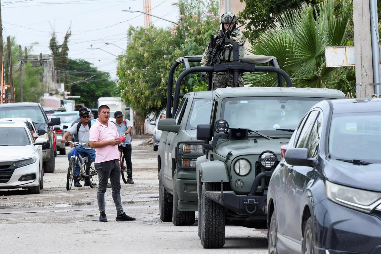 Onlookers and soldiers outside Secondary School No. 13 in the Mexican city of Torreon on Oct 1, after the attack.