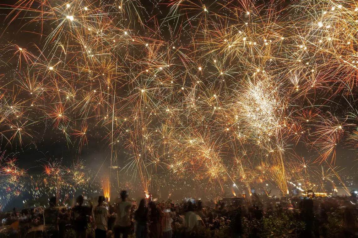 People celebrating the New Year in Palu, Central Sulawesi province, Indonesia, Jan 1, 2024. 