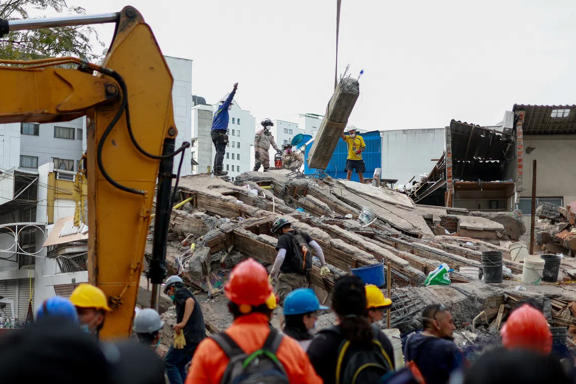 Rescuers search for survivors amid destroyed buildings after the Colombia earthquake.