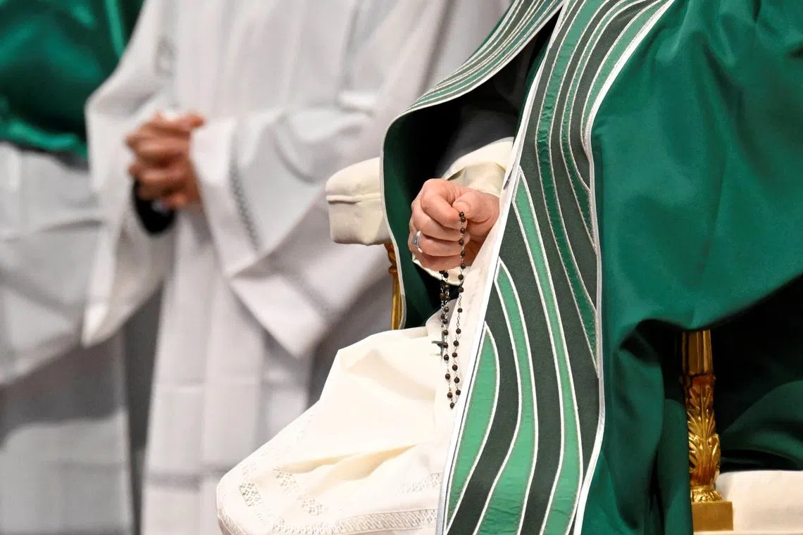 FILE PHOTO: Pope Francis holds rosary beads as he presides over the closing Mass at the end of the Synod of Bishops in Saint Peter's Basilica at the Vatican, October 29, 2023. Vatican Media/­Handout via REUTERS/File Photo
