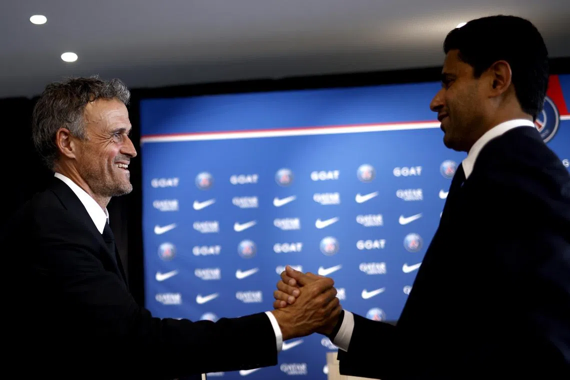 Spanish coach Luis Enrique (left) shaking hands with Nasser Al-Khelaïfi, chairman and CEO of Paris Saint-Germain, during his presentation as new head coach of PSG.
