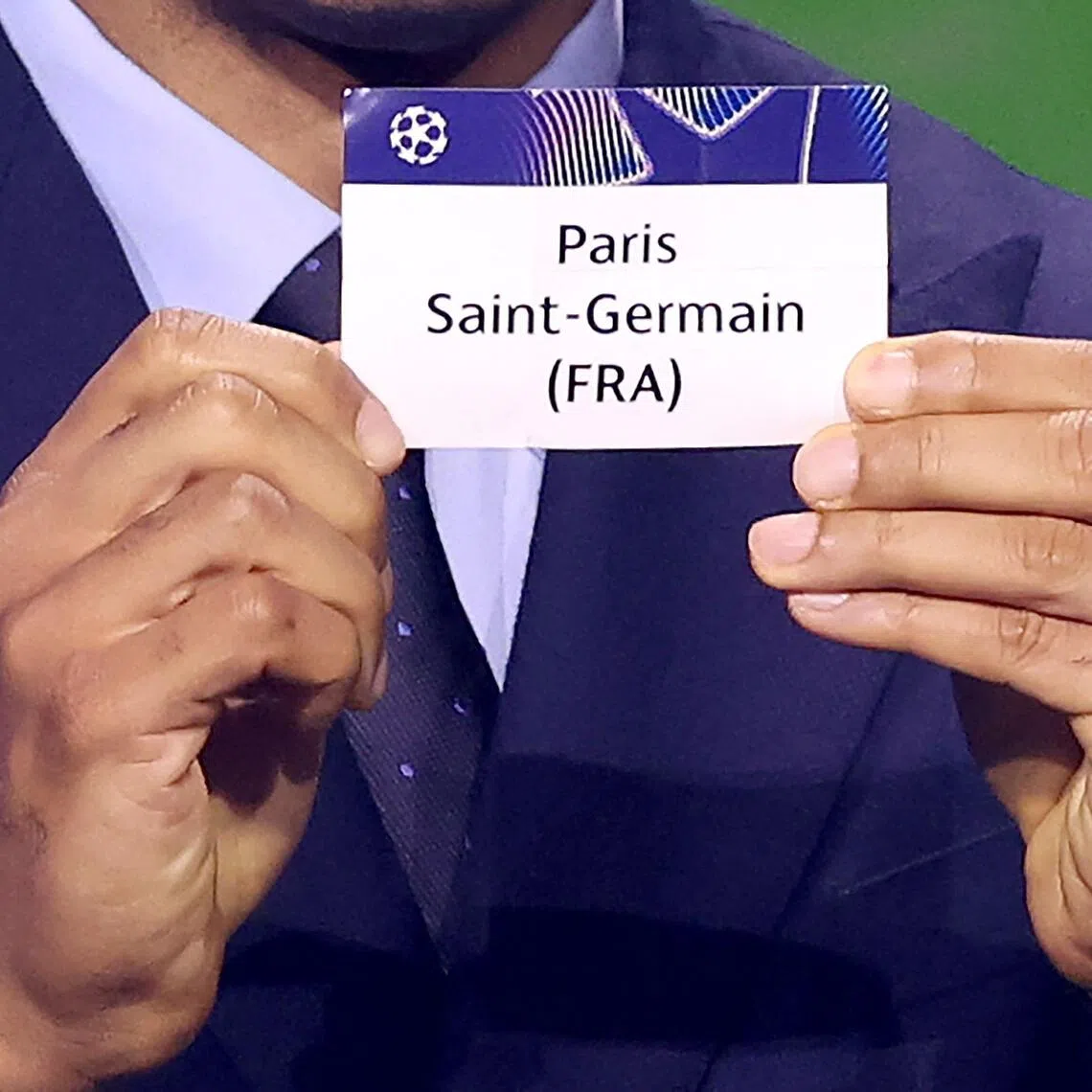 Former French footballer Thierry Henry showing the paper slip for holders PSG, during the Champions League draw on Aug 27 in Monaco.
