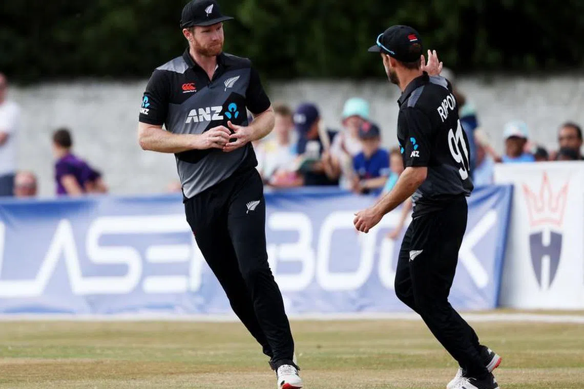 FILE PHOTO: Cricket - T20 Series - Scotland v New Zealand - The Grange Club, Edinburgh, Scotland, Britain - July 29, 2022 New Zealand's Jimmy Neesham celebrates with Michael Rippon after taking a catch to dismiss Scotland's Mark Watt REUTERS/Russell Cheyne/File Photo