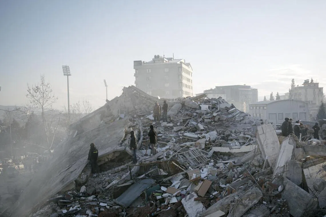 Civilians search for missing relatives amidst the rubble of collapsed buildings in Kahramanmaras, Turkey on Feb 7, 2023.