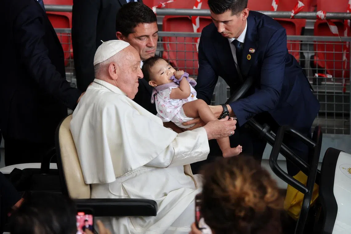 Pope Francis blessing babies and children at the National Stadium before the mass. 