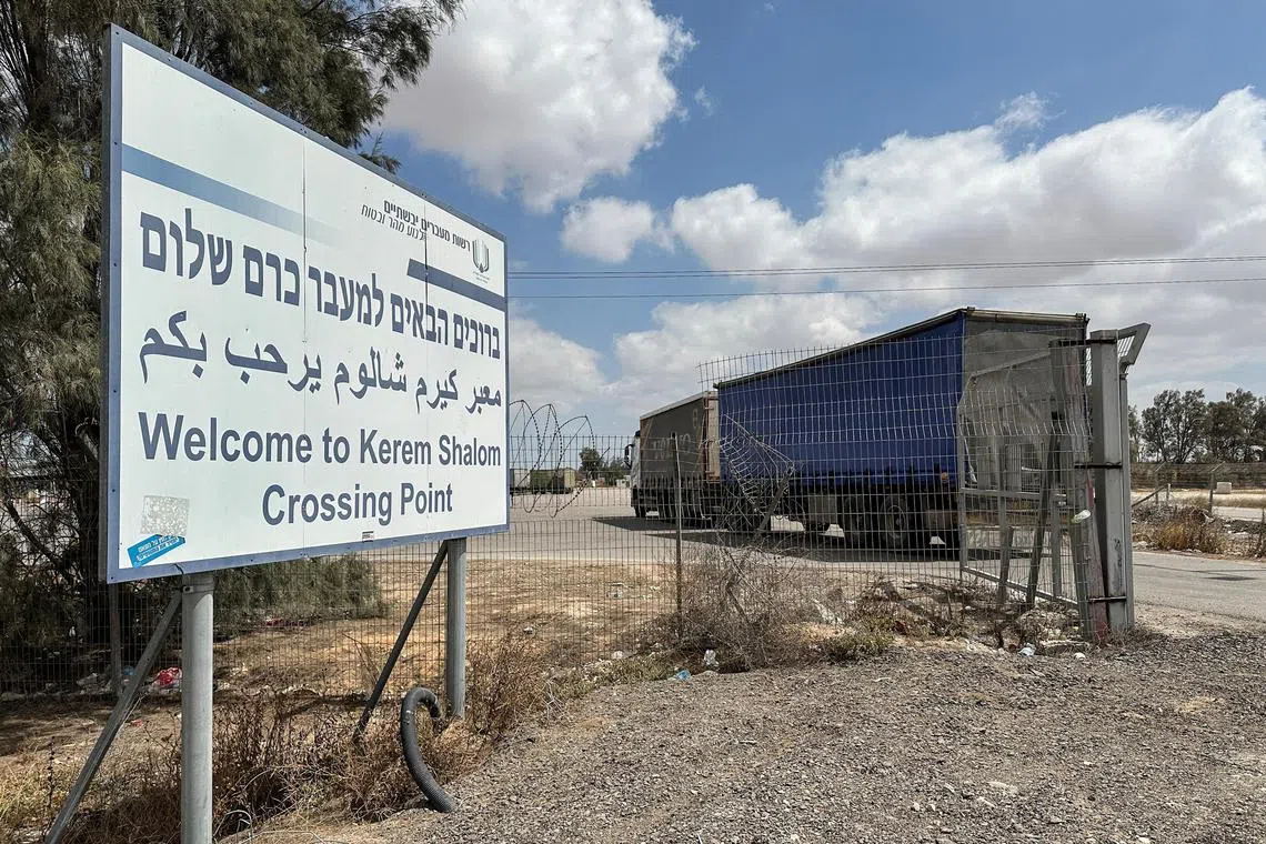 A truck carrying aid arrives at the Kerem Shalom crossing between Israel and Gaza.