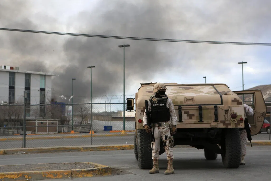 Members of the Mexican Army guard the area outside the prison where a riot took place, in Ciudad Juarez, Mexico.