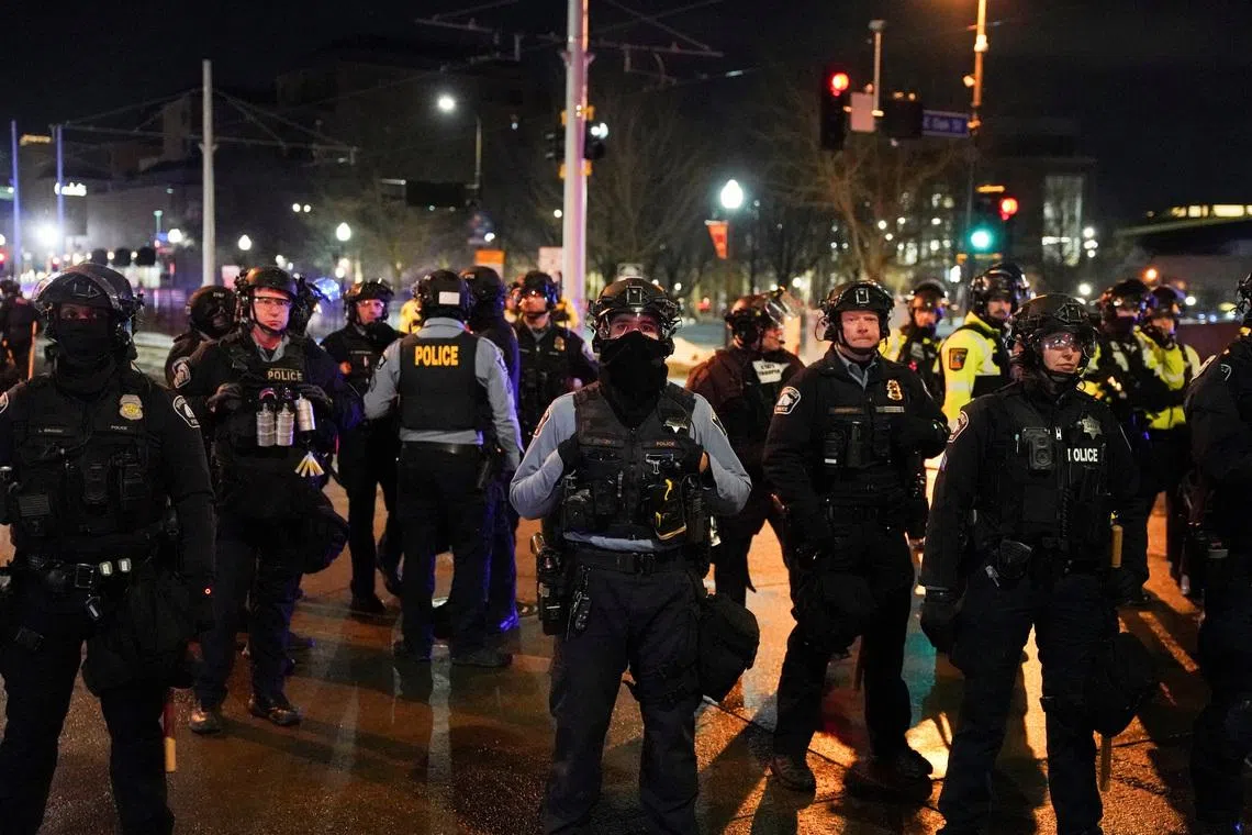 Local and state police stand guard after declaring unlawful assembly, as demonstrators gathered outside a hotel they believe is being used by federal agents, amid increased immigration enforcement in Minneapolis, Minnesota, U.S., February 5, 2026. REUTERS/Seth Herald