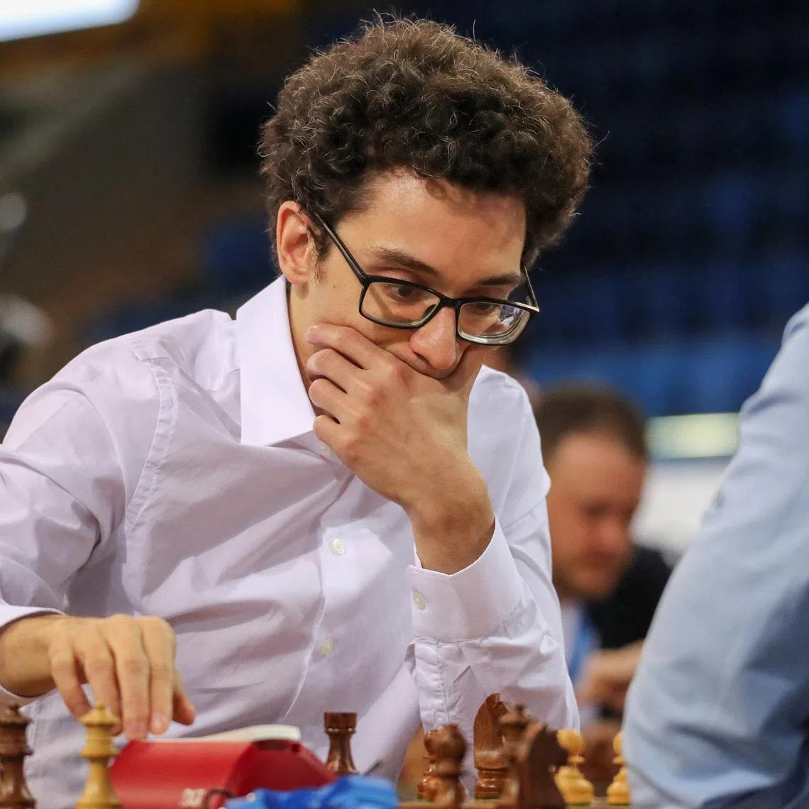 FILE PHOTO: Chess - FIDE World Rapid and Blitz Championships 2022 - Blitz Open - Almaty, Kazakhstan - December 30, 2022. Fabiano Caruana of the U.S. sits in front of a chess board during a game. REUTERS/Pavel Mikheyev/File Photo