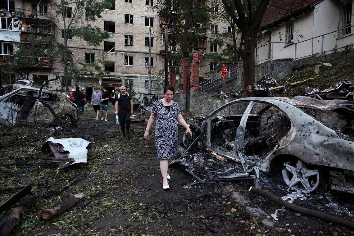 Residents walk past burned out cars following overnight Russian missile and drone strikes, amid Russia’s attack on Ukraine, in Kyiv, Ukraine, July 2, 2026. REUTERS/Alina Smutko TPX IMAGES OF THE DAY