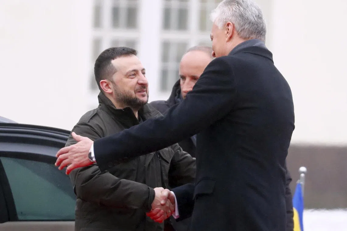 Lithuanian President Gitanas Nauseda (right) welcomes Ukrainian President Volodymyr Zelensky in Vilnius, Lithuania.
