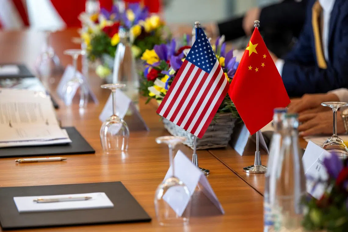 FILE PHOTO: The American and Chinese flags are photographed on the negotiating table, during a bilateral meeting between the United States and China, in Geneva, Switzerland, May 10, 2025. KEYSTONE/EDA/Martial Trezzini/Handout via REUTERS/ File Photo