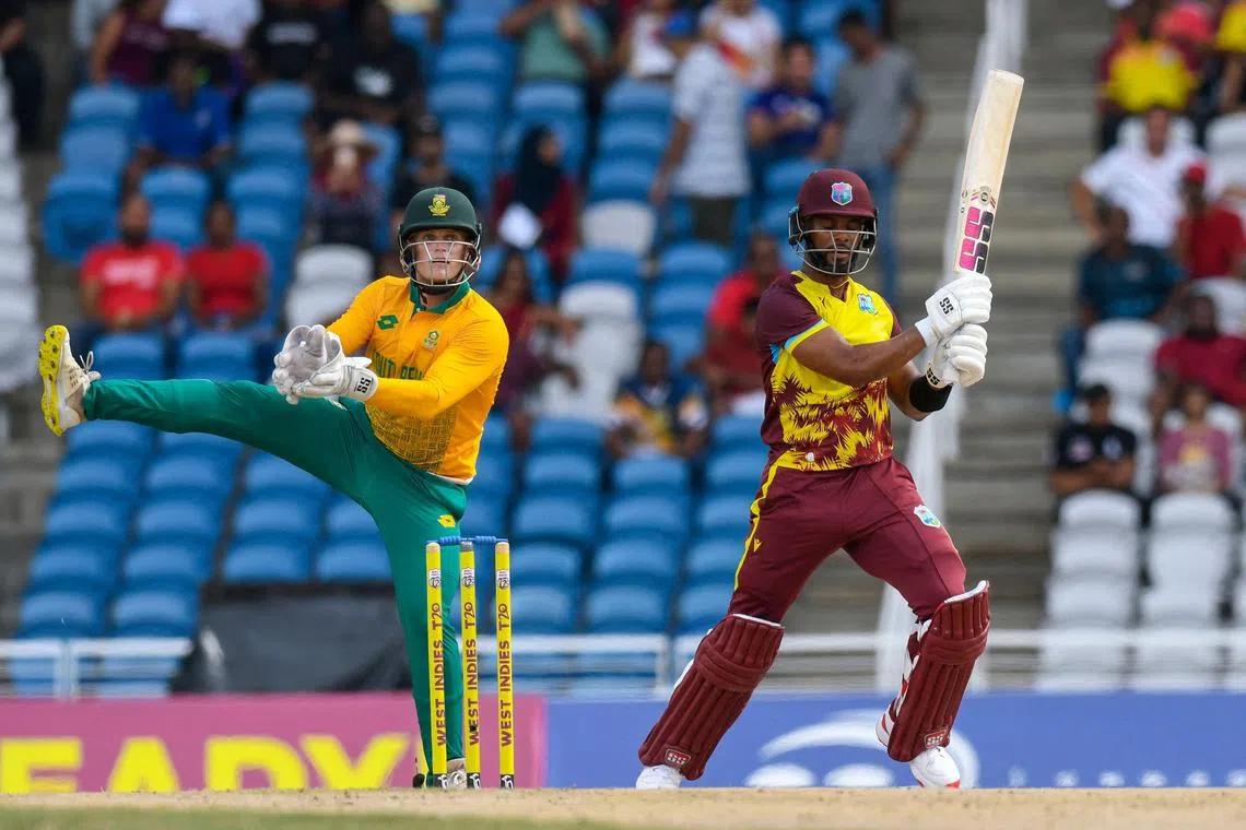 Shai Hope of West Indies hits a four as Ryan Rickelton of South Africa prepared to catch in the 2nd T20I match at Brian Lara Cricket Academy in Tarouba, Trinidad and Tobago, on Aug 25, 2024.