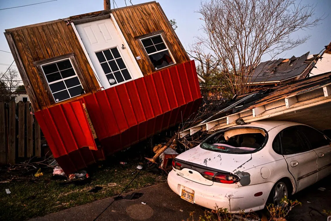 Shocked rescue workers surveyed the damage with roofs blown away, buildings flattened and cars smashed together amid piles of debris.