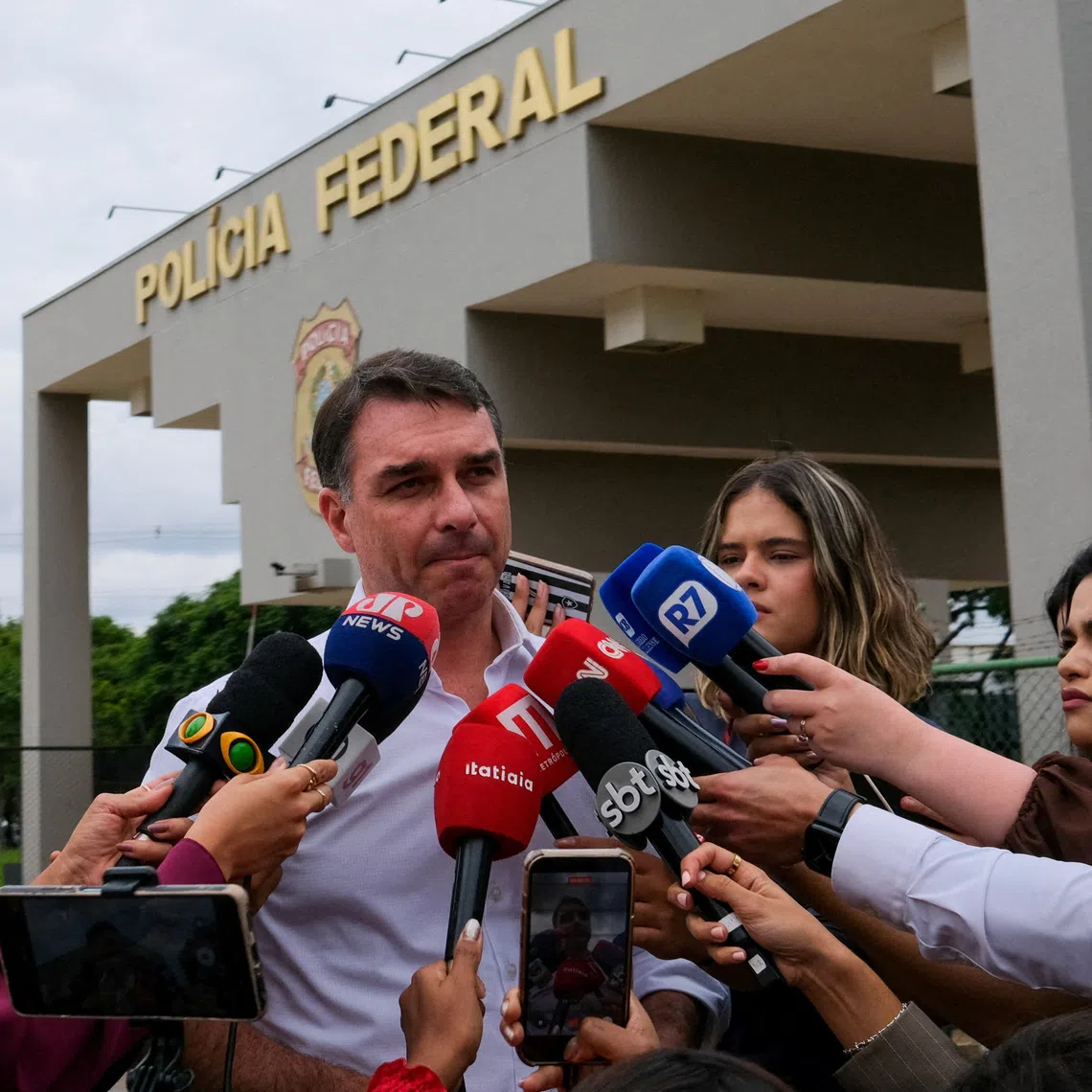 FILE PHOTO: Senator Flavio Bolsonaro, Brazil's former President Jair Bolsonaro's son, speaks to the media after visiting his father at a Federal Police building in Brasilia, Brazil, December 16, 2025. REUTERS/Diego Herculano/File Photo