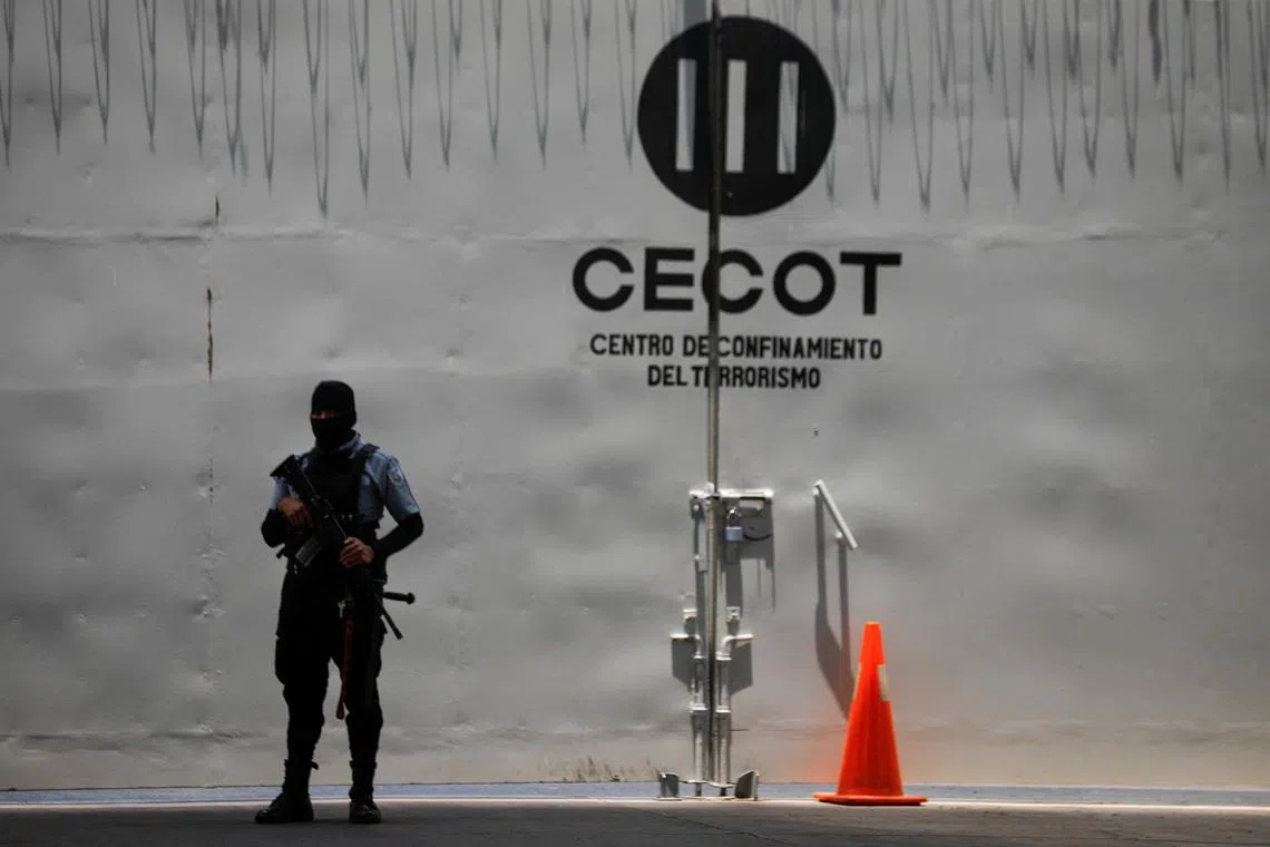 A prison guard stands near a CECOT logo at the Terrorism Confinement Center (CECOT) in Tecoluca, El Salvador, April 23, 2026.REUTERS/Jose Cabezas