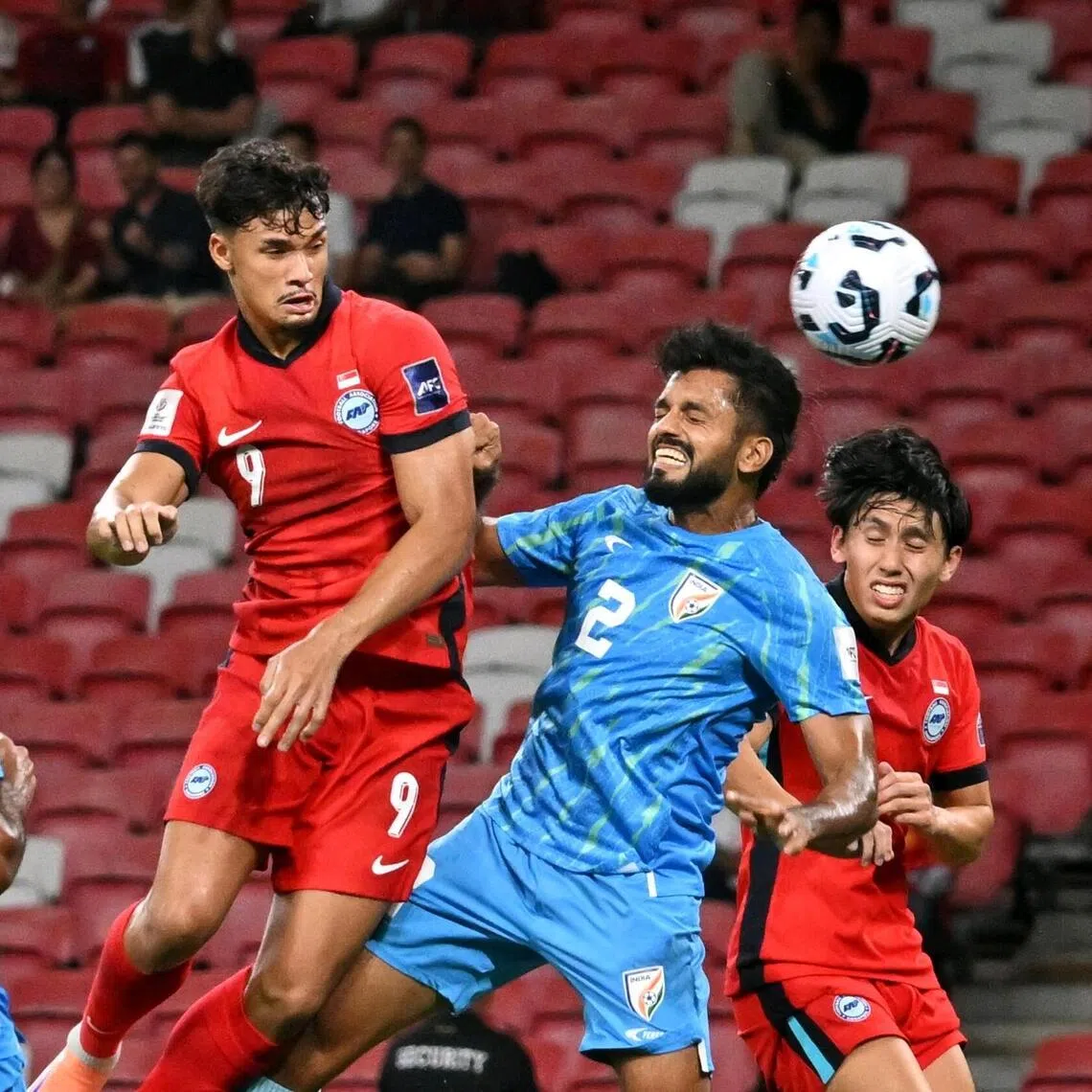 Singapore’s Ikhsan Fandi heading the ball as India’s Rahul Bheke (No. 2) attempts to stop him during an Asian Cup qualifying 1-1 draw in October 2025.