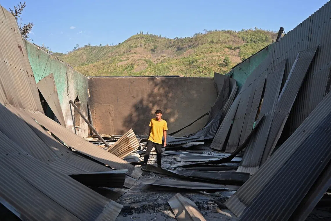 A villager inspects the debris of a ransacked church that was set on fire in Heiroklian village, Manipur, on Monday. 