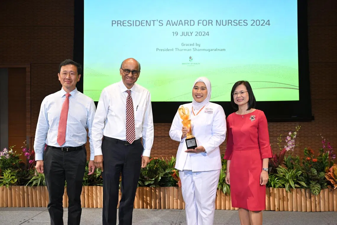 Ms Elena Mohamed Ayob (second from right) receiving the President’s Award for Nurses from President Tharman Shanmugaratnam at The Star Gallery on July 19.