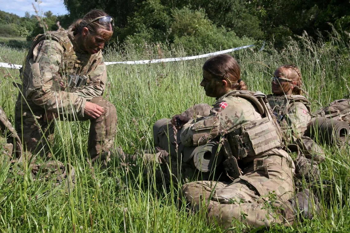 FILE PHOTO: Volunteers in the Danish Royal Life Guards rest during a training exercise in Hovelte, Denmark, June 11, 2025. REUTERS/Tom Little//File Photo