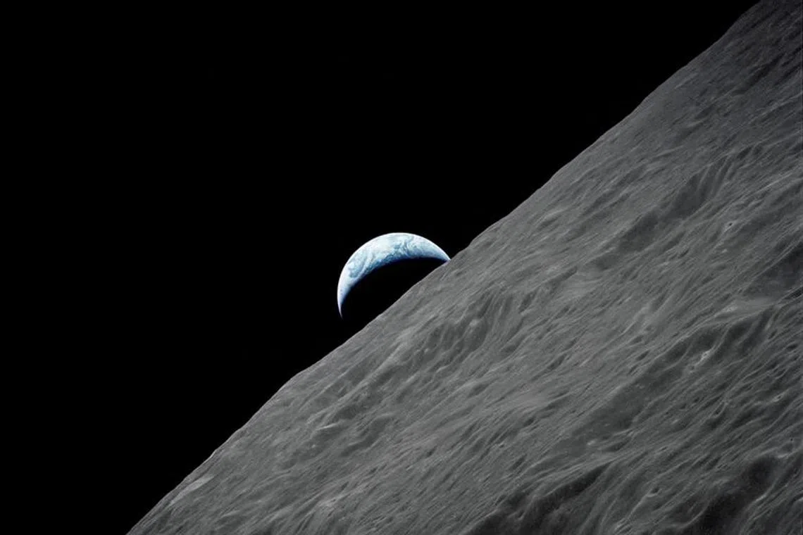 FILE PHOTO: The crescent Earth rises above the lunar horizon in this undated NASA handout photograph taken from the Apollo 17 spacecraft in lunar orbit during the final lunar landing mission in the Apollo program in 1972. REUTERS/NASA/Handout/File Photo
