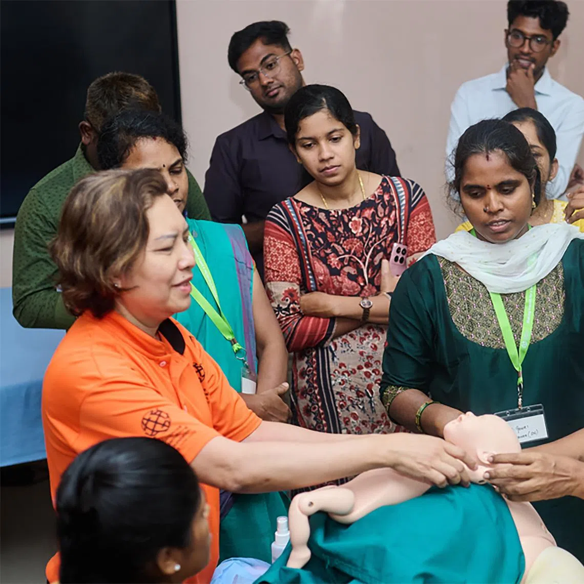 stvolunteering - Senior Nurse Clinician Maria Binte Jumhasan (in orange), a Singapore International Volunteer, demonstrates how to manage a breech delivery at a district hospital in Chennai, Tamil Nadu. (Photo: Singapore International Foundation) Copyright: ST