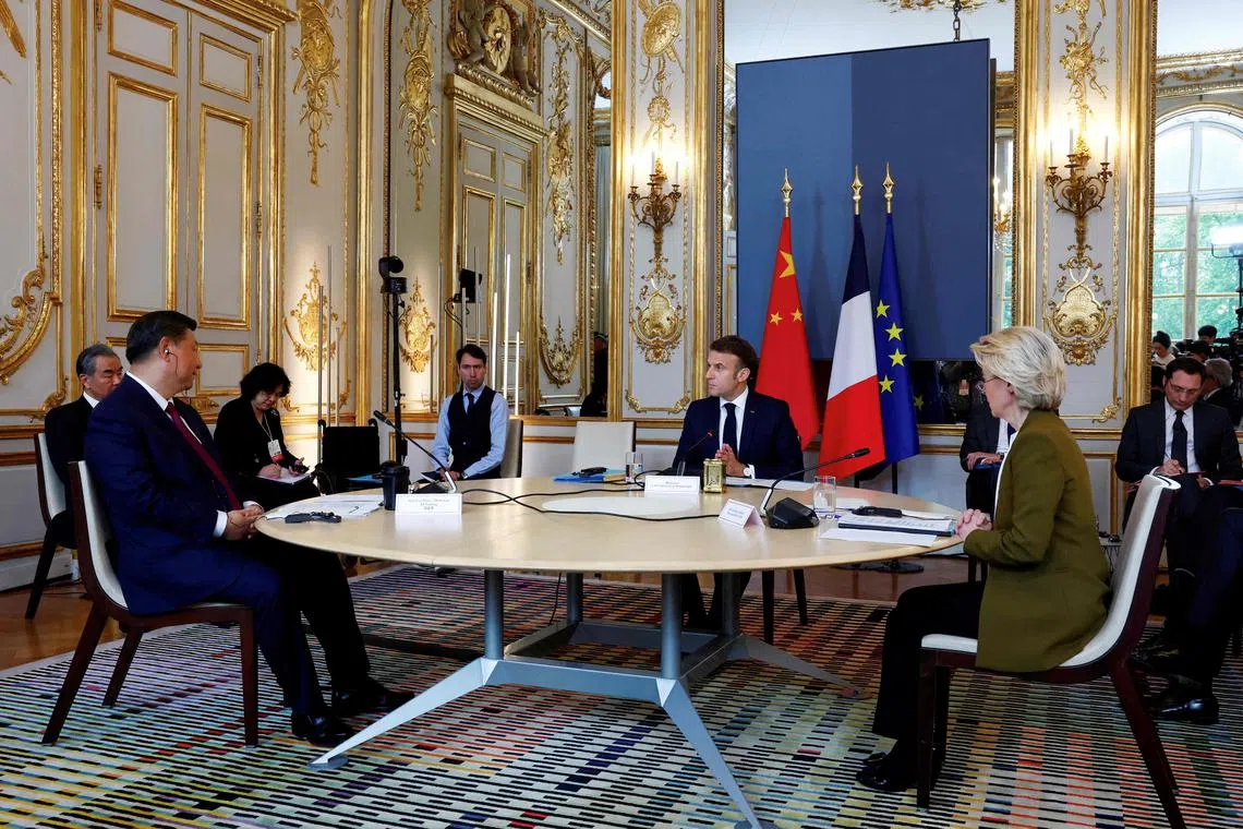 (From left) Mr Xi, Mr Macron and Dr von der Leyen hold a trilateral meeting as part of the Chinese president's two-day state visit, at the Elysee Palace in Paris.