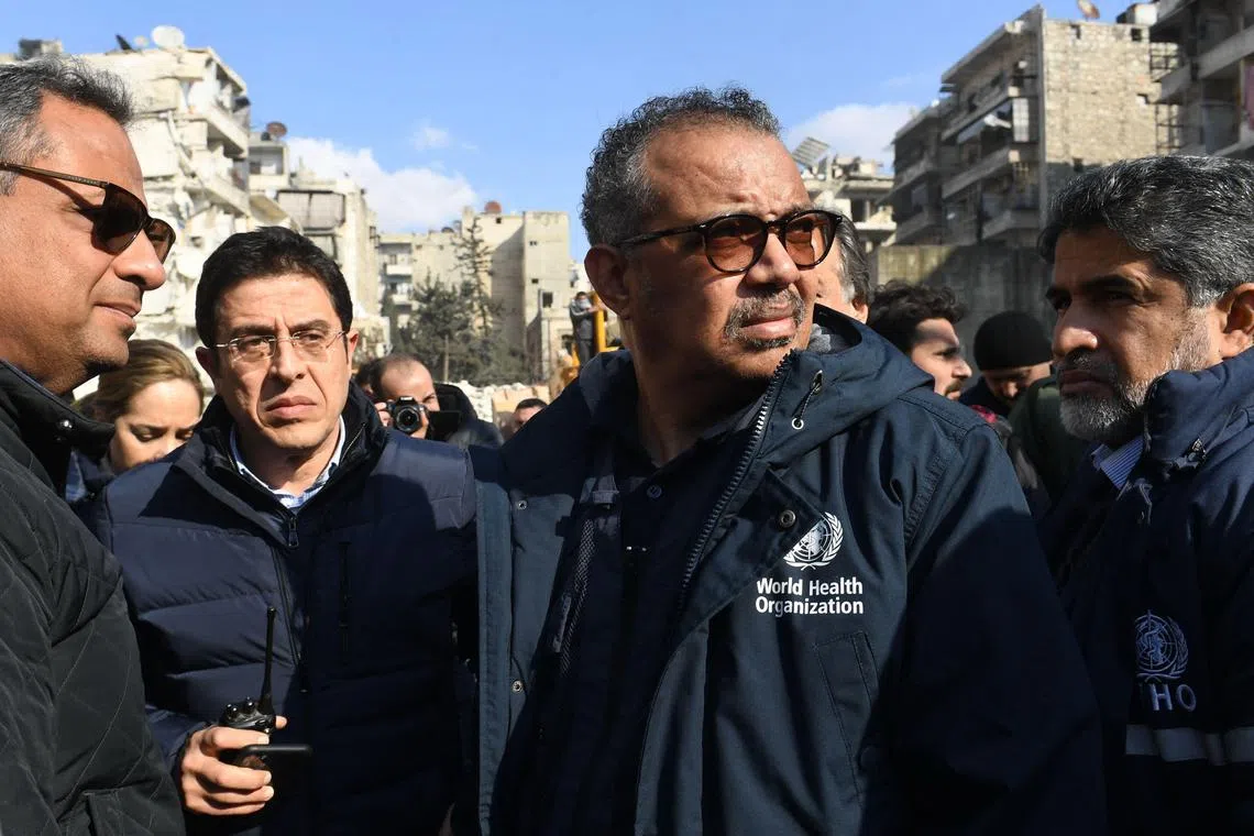 WHO chief Tedros Adhanom Ghebreyesus (centre) visits a quake-hit area in the northern Syrian city of Aleppo, on Feb 11, 2023.