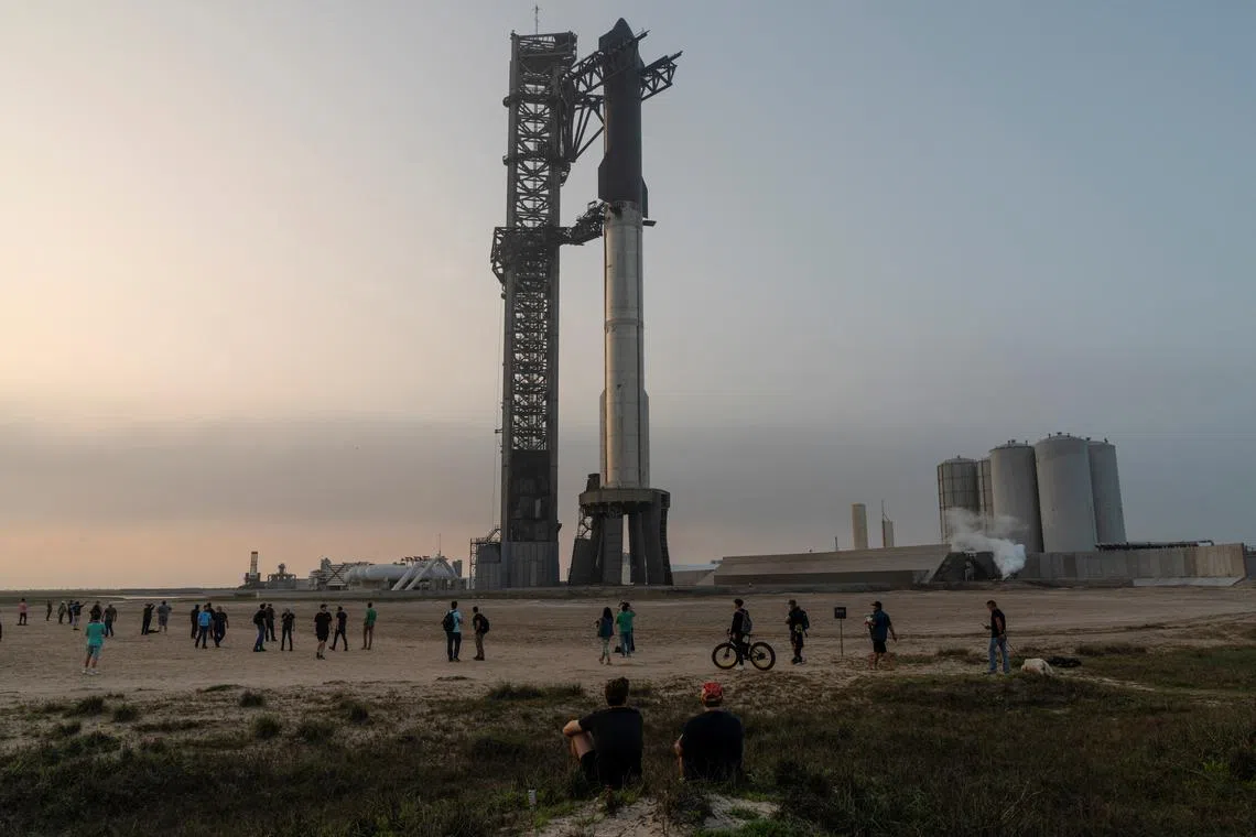 Spectators gather as SpaceX's next-generation Starship spacecraft atop its powerful Super Heavy rocket is prepared for a third launch from the company's Boca Chica launchpad on an uncrewed test flight, near Brownsville, Texas, U.S. March 13, 2024. REUTERS/Cheney Orr