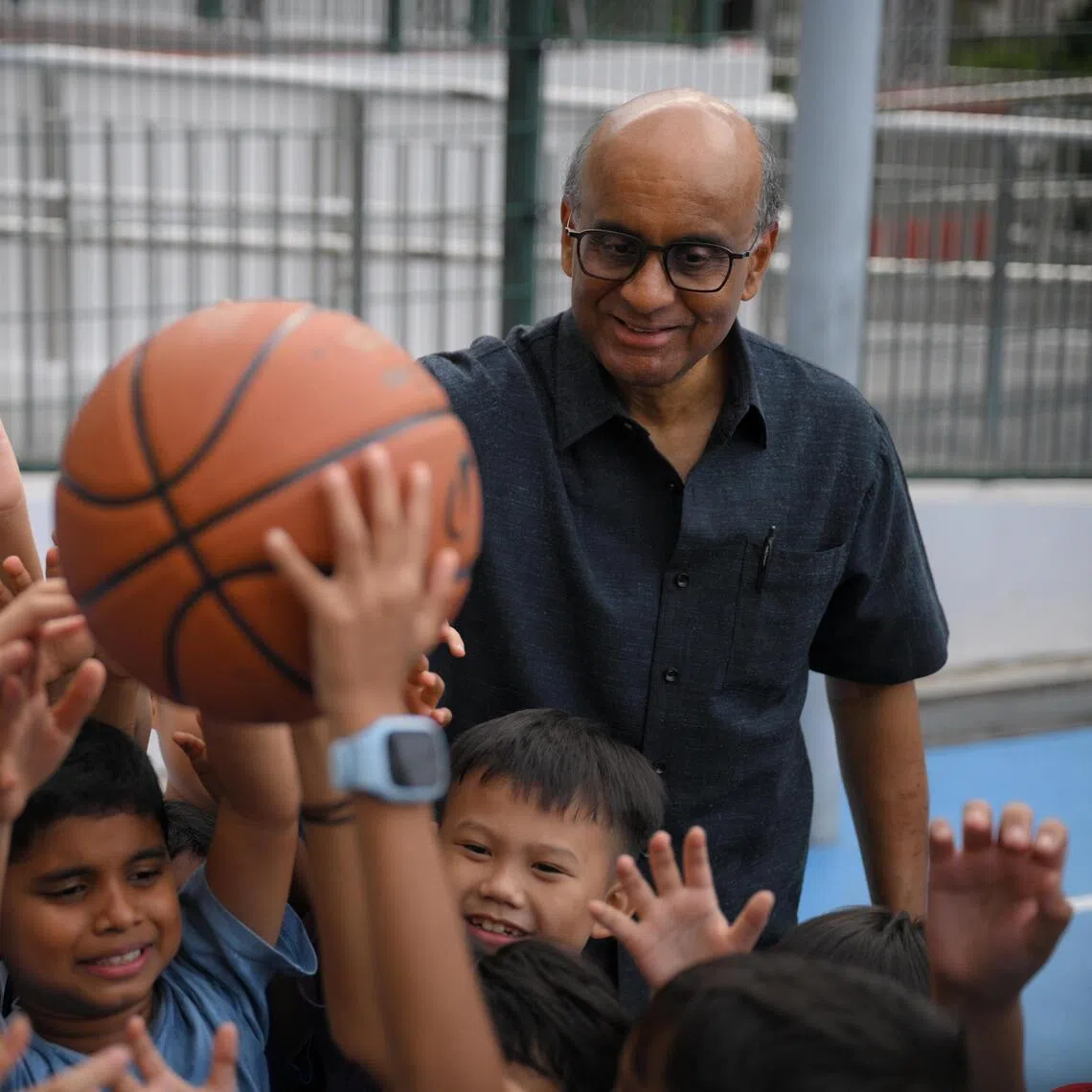 President Tharman Shanmugaratnam with beneficiaries during a visit to Reach Family Service Centre in Sin Ming on April 30.