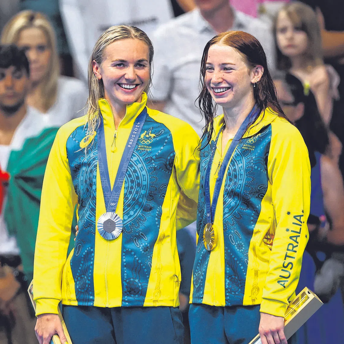 Paris 2024 Olympics - Swimming - Women's 200m Freestyle Victory Ceremony - Paris La Defense Arena, Nanterre, France - July 29, 2024. Gold medallist Mollie O'Callaghan of Australia celebrates on the podium with silver medallist Ariarne Titmus of Australia. REUTERS/Evgenia Novozhenina