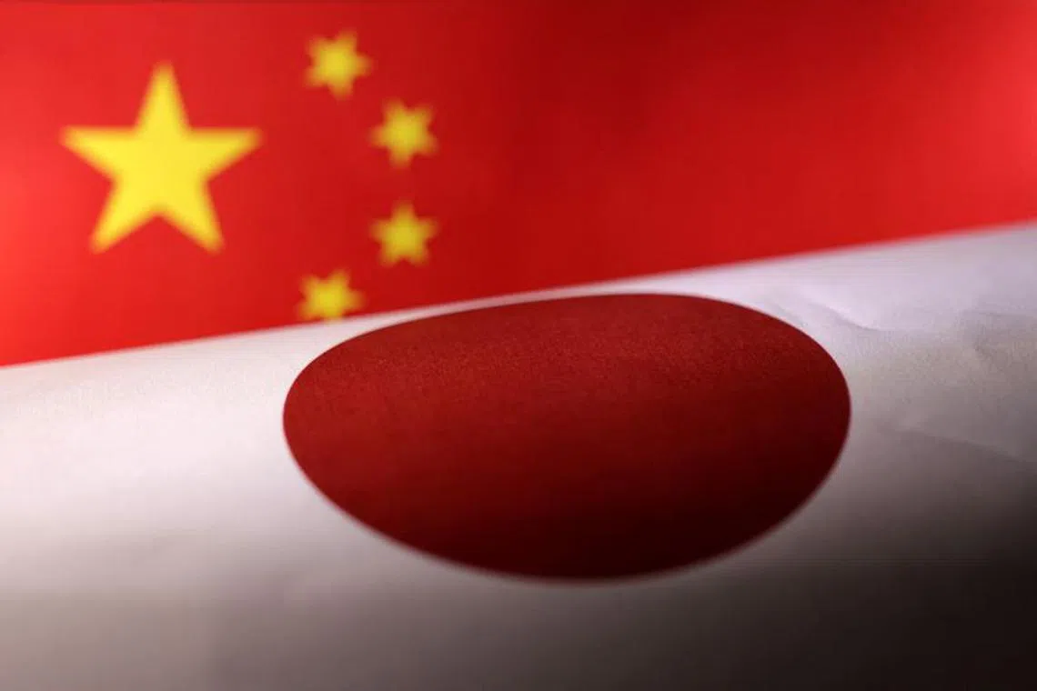 Printed Chinese and Japanese flags are seen in this illustration, July 21, 2022. REUTERS/Dado Ruvic/Illustration REFILE - CORRECTING YEAR