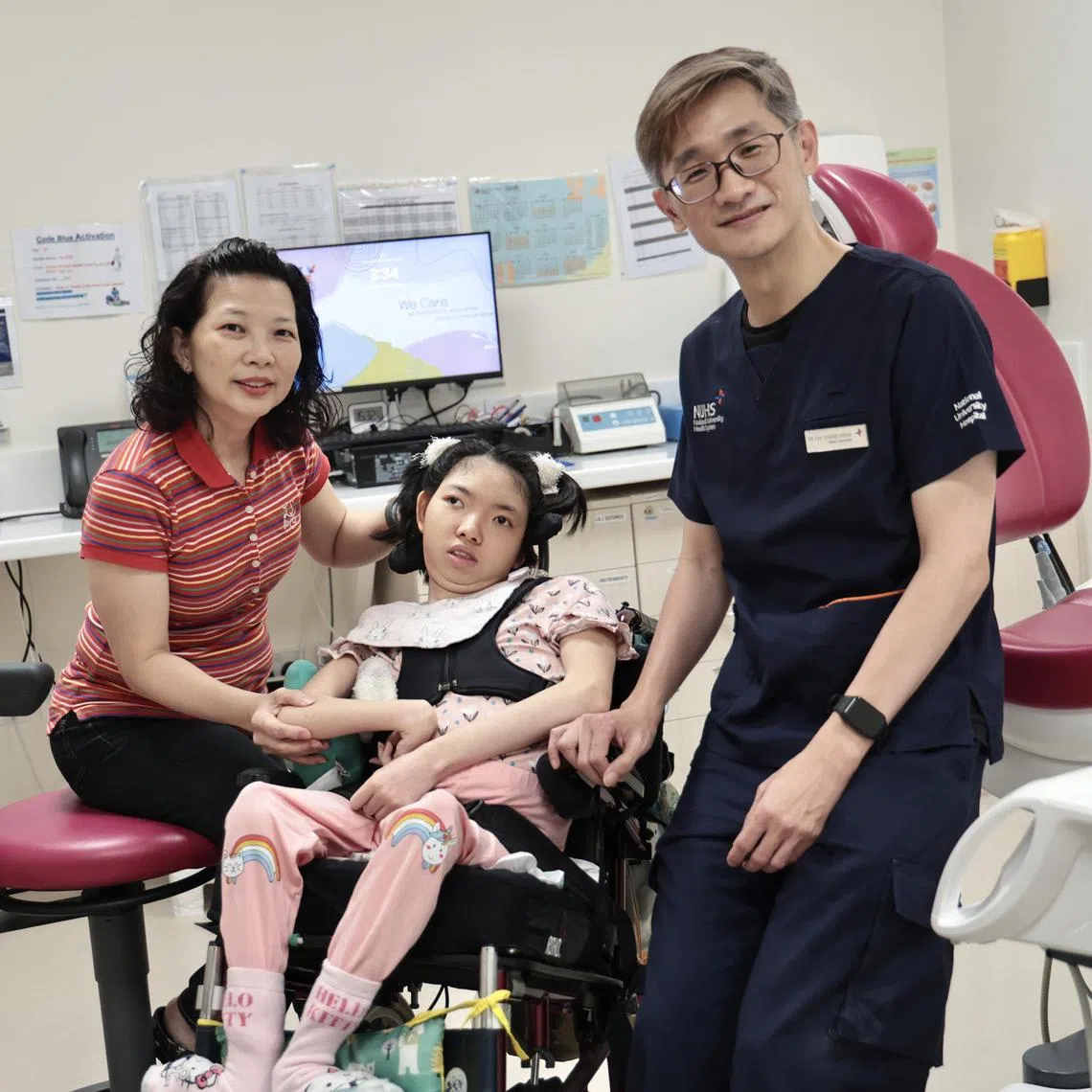 Cerebral palsy patient Hillary Chua with her mother Cindy Wong and Dr Tay Chong Meng, division head of advanced general dental practice at the National University Centre for Oral Health Singapore.