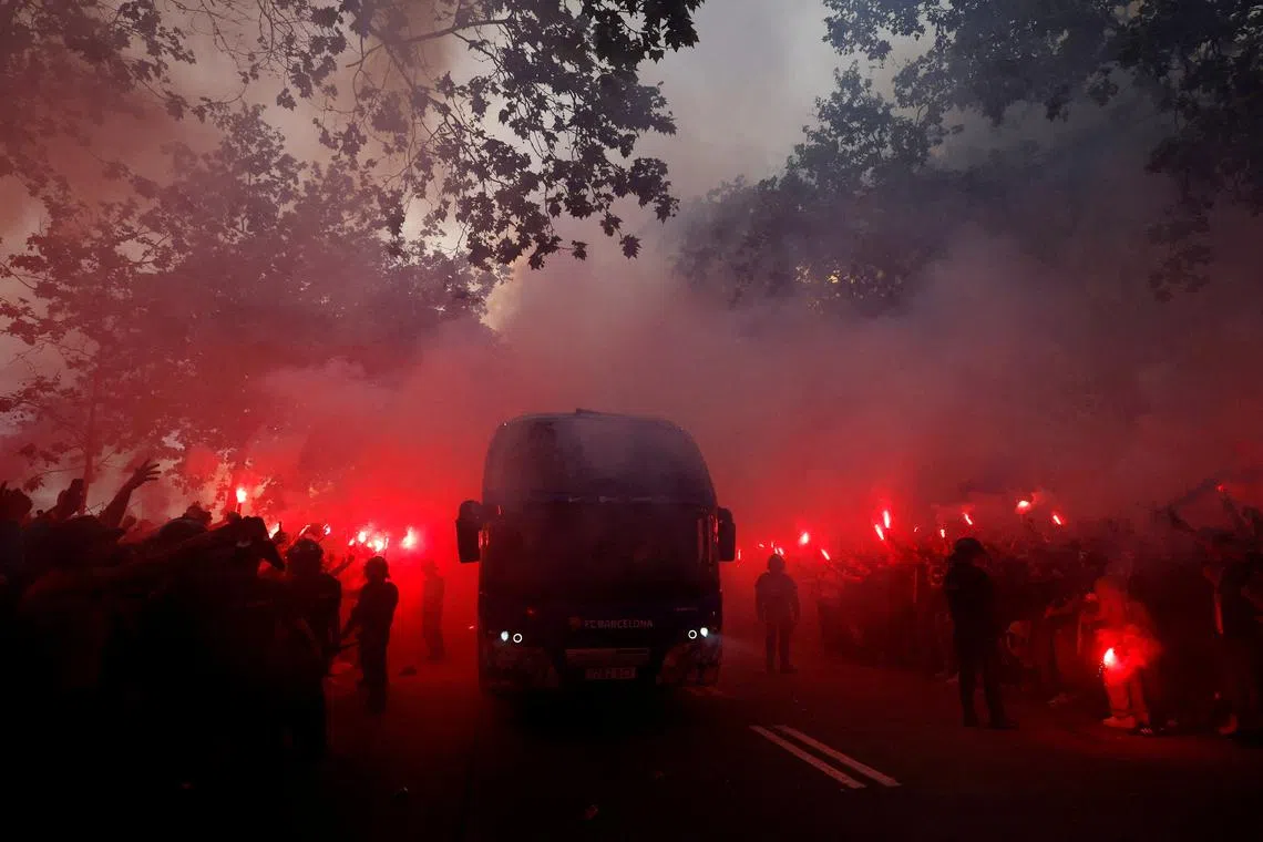 Fans with flares as the FC Barcelona team bus arrives outside the stadium before the Champions League quarter final match between FC Barcelona and Paris St Germainmatch held at the Lluís Companys Olympic Stadium, in Barcelona, Spain, on April 16, 2024.
