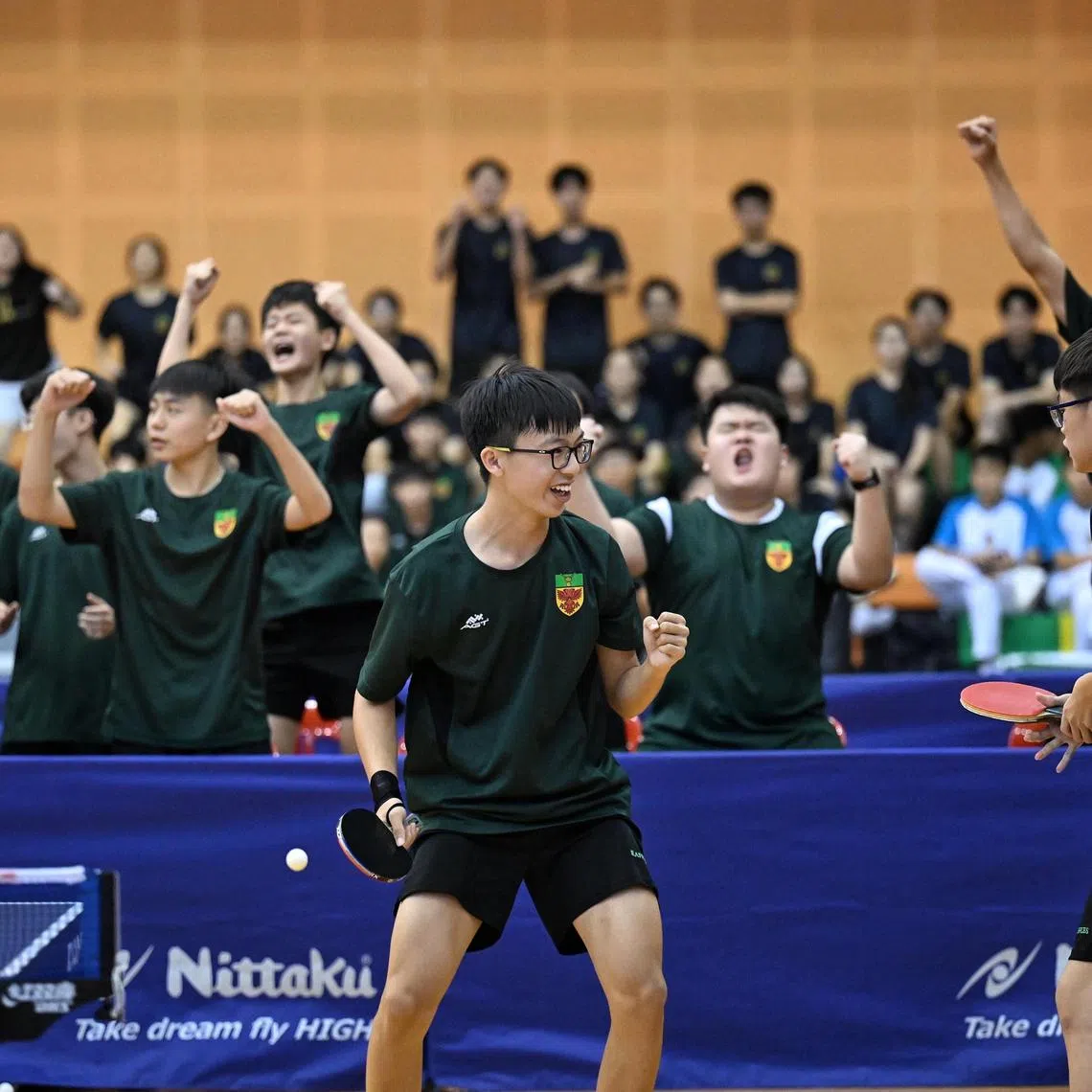 Jaden Koh (left) and Owen Lim from Raffles Institution react after winning the deciding match that crowned them champions in the B Division boys' table tennis final against Hwa Chong Institution on April 9, 2025.