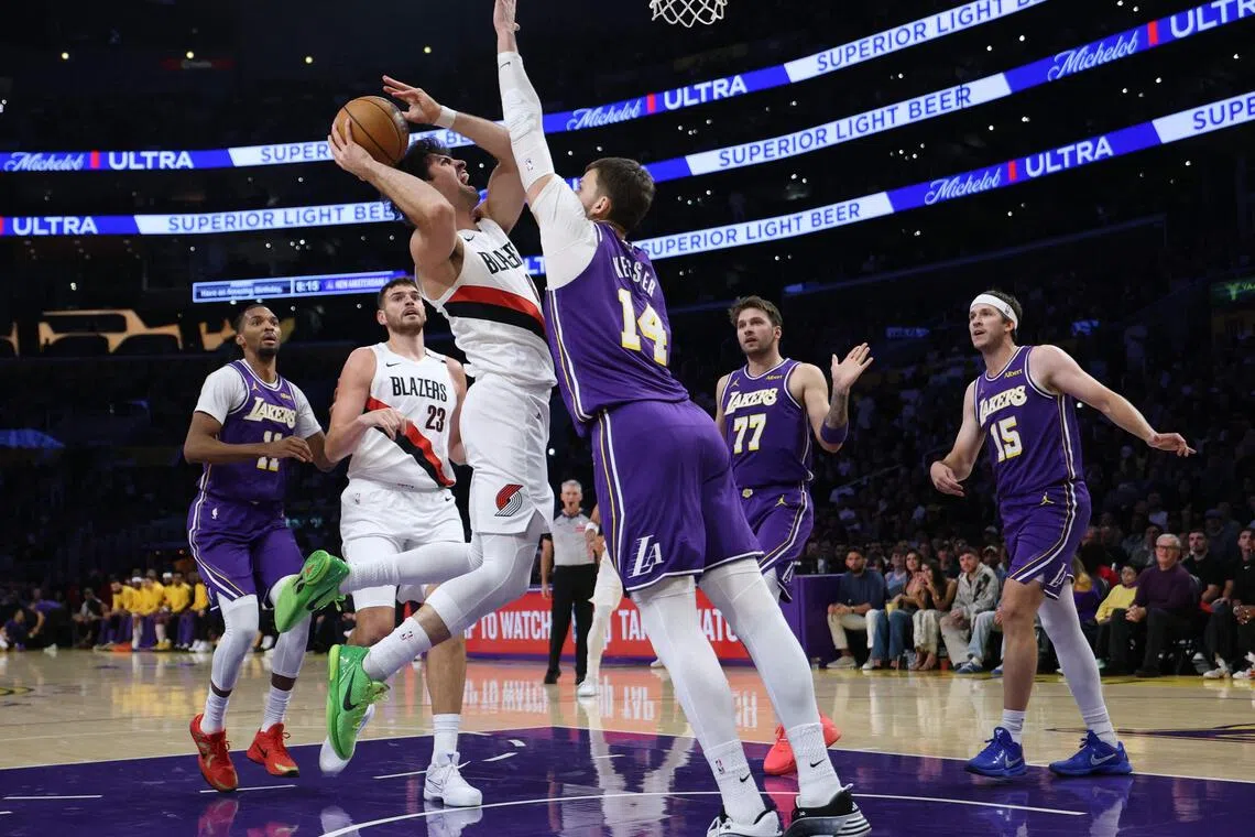 Deni Avdija of the Portland Trail Blazers attempting a shot in front of Walker Kessler of the Los Angeles Lakers during the first half on Oct 27 in Los Angeles.