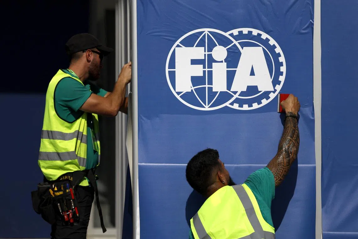 FILE PHOTO: Formula One F1 - Abu Dhabi Grand Prix - Yas Marina Circuit, Abu Dhabi, United Arab Emirates - December 5, 2024 Workers prepare FIA branding in the paddock ahead of the grand prix REUTERS/Hamad I Mohammed/File Photo