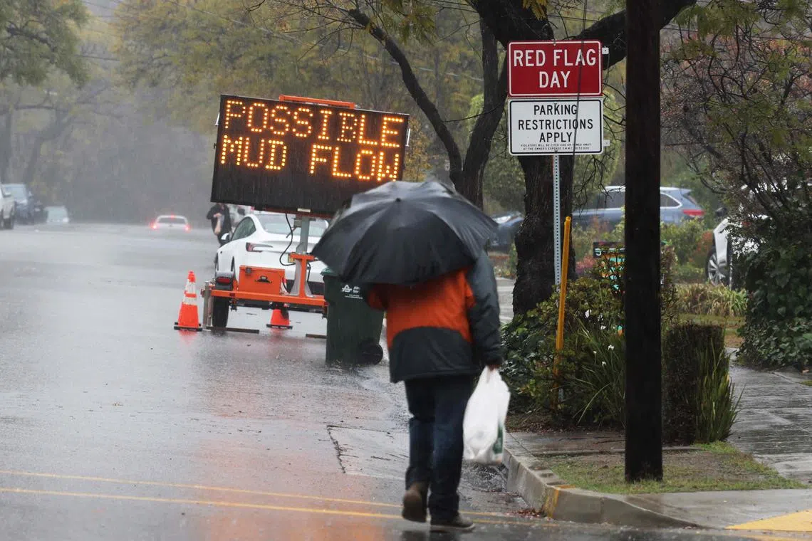 A traffic sign reads “Possible Mud Flow” in a neighborhood with mandatory evacuations ordered as an atmospheric river bring heavy rains in Sierra Madre, California, on February 13, 2025. Residents of southern Californians are evacuating their homes because of the heavy rain and debris flows that threaten mudslides in areas recovering from wildfires. (Photo by David Swanson / AFP)